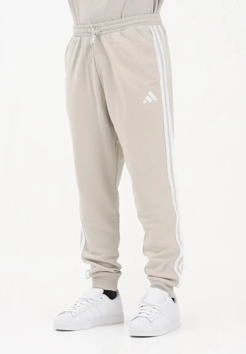 Pantalone sportivo ESSENTIALS THREE STRIPES FRENCH TERRY beige da uomo