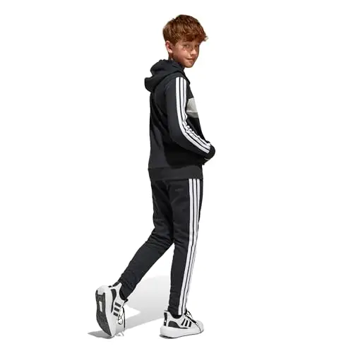 adidas Unisex - Bambini SEASONAL ESSENTIALS TIBERIO 3 STRIPES FLEECE TRACKSUIT, black/white/grey two, 13 miniatura 2