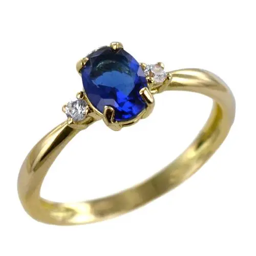 anello in oro giallo con zircone ovale blu e zirconi bianchi
