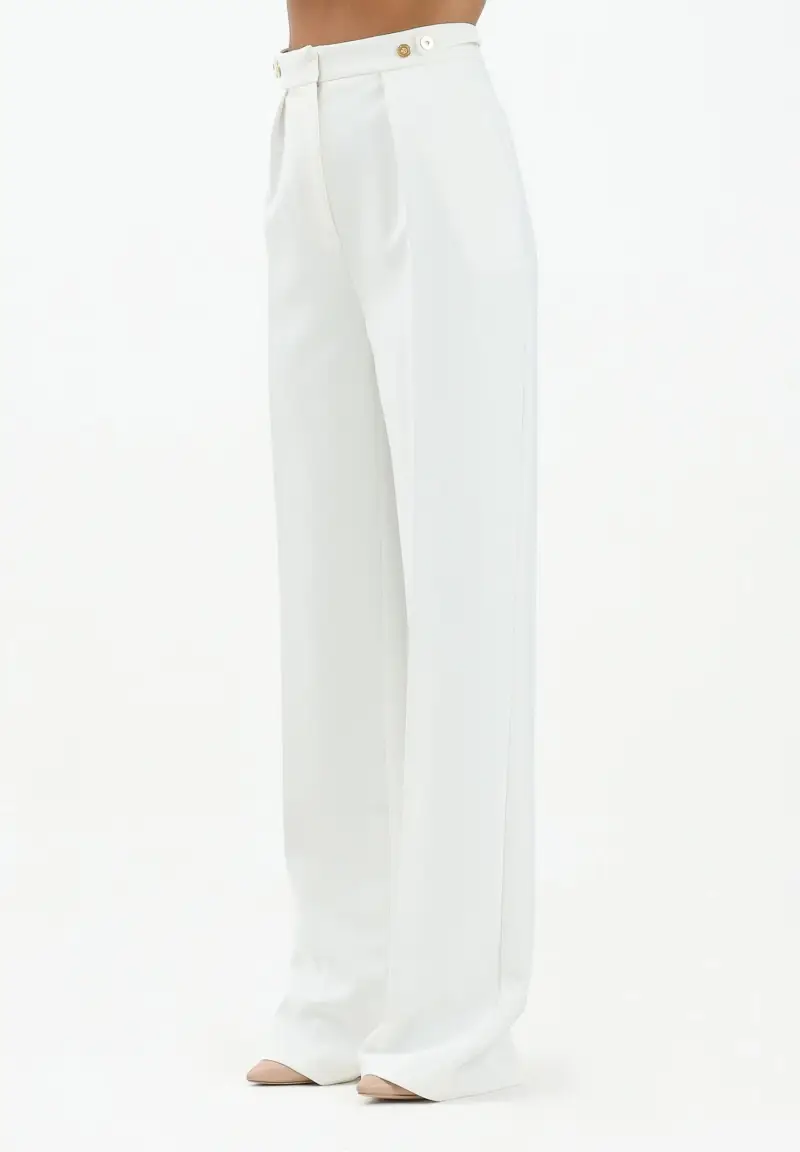 Pantalone elegante avorio da donna con accessorio gioiello