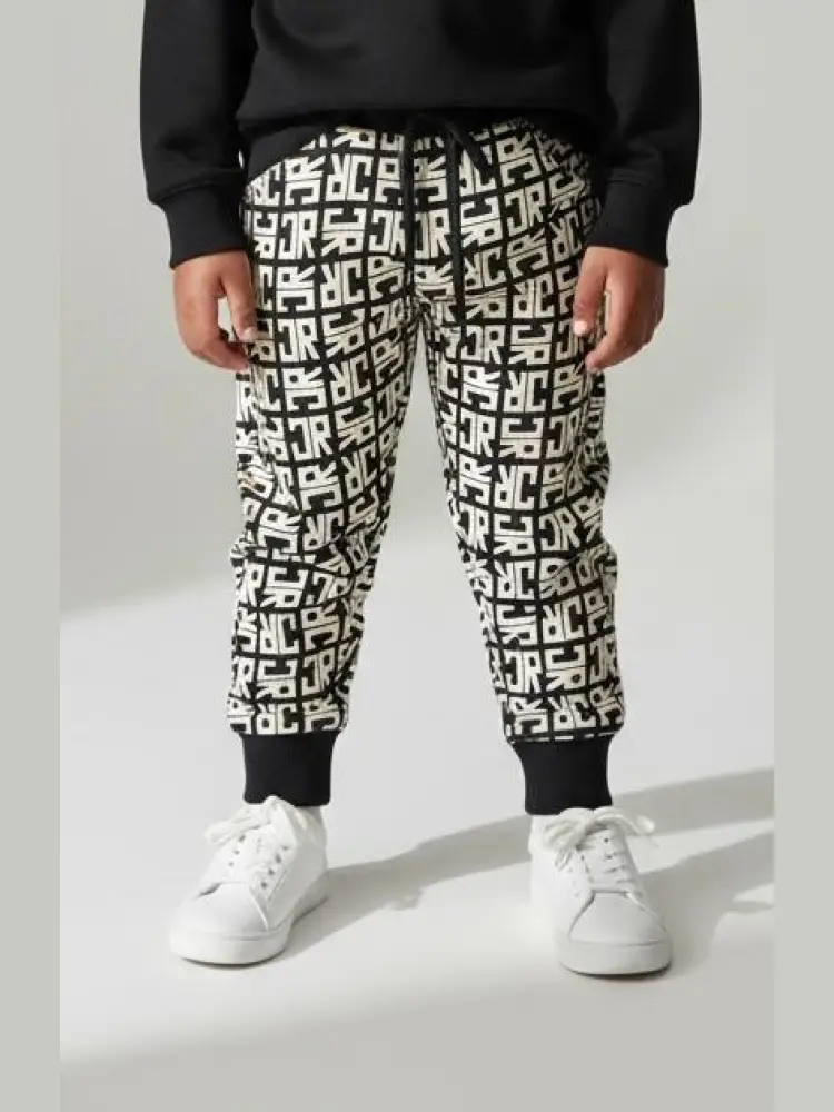 pantalone di tuta kids/junior con polsini e logo all over nero/bianco