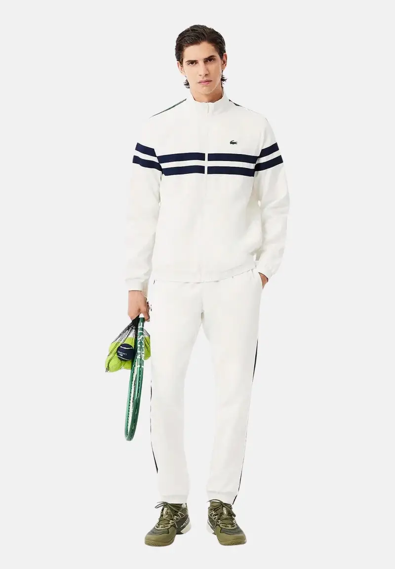 LA COSTE tuta da uomo in tessuto tecnico bianco con inserti verdi e due bande orizzontali blu navy sul petto