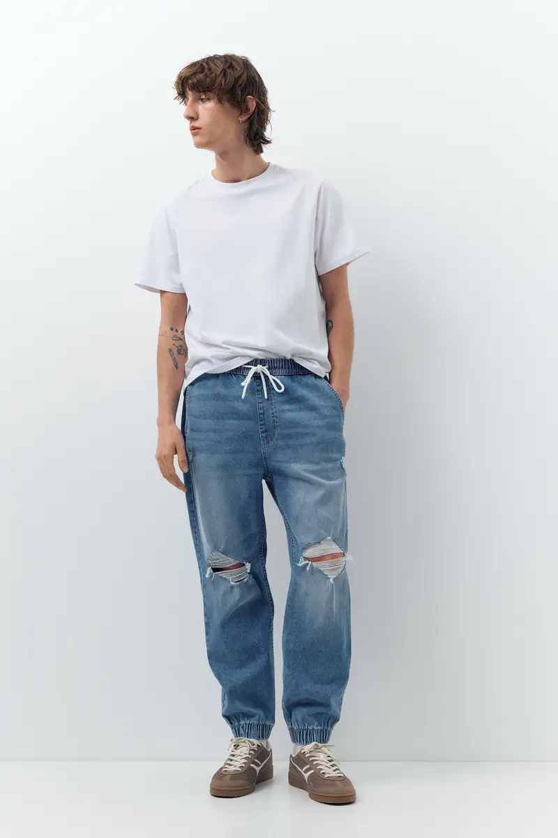 Pantaloni Jogger In Denim Strappati Indigo chiaro