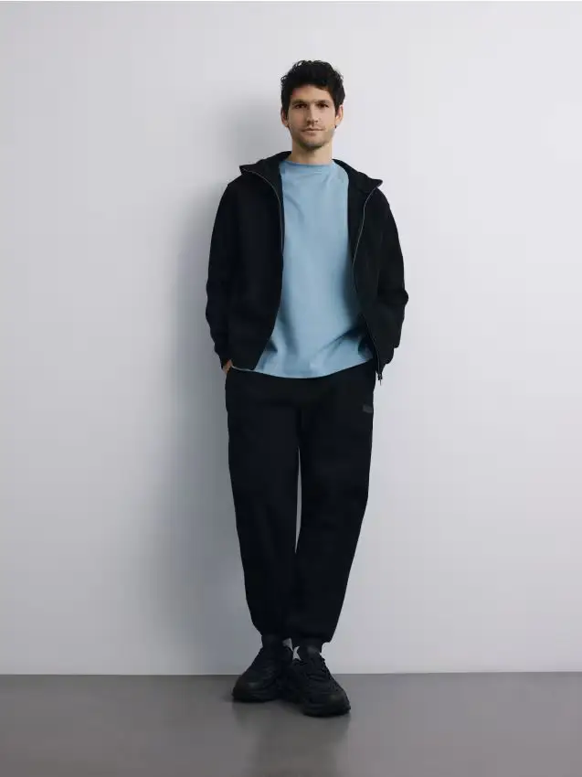 Top da jogging con zip e cappuccio - nero