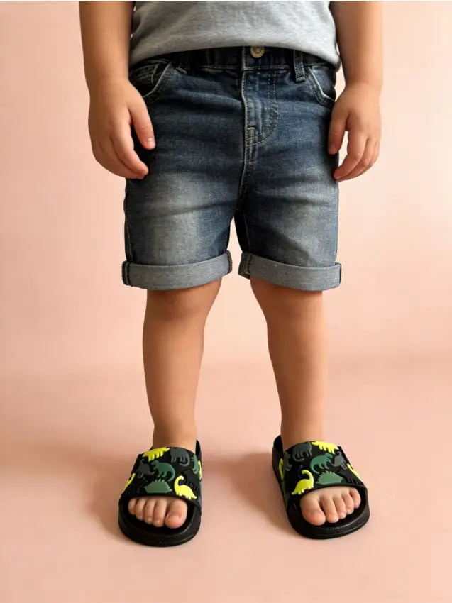 Ciabatte con motivo dinosauri ed elastico sul tallone - nero